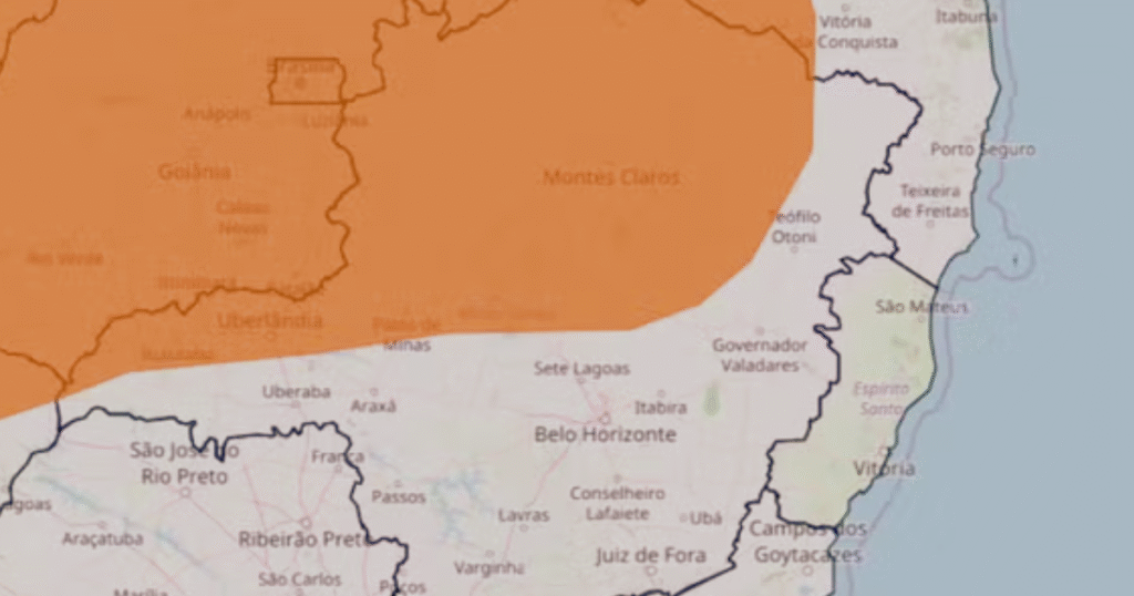 Imagem ilustrando alerta laranja do INMET com ventos fortes, nuvens carregadas e chuva intensa em Montes Claros e regiões Norte, Centro e Noroeste de Minas Gerais, indicando risco de alagamentos e temporais entre domingo e segunda-feira.